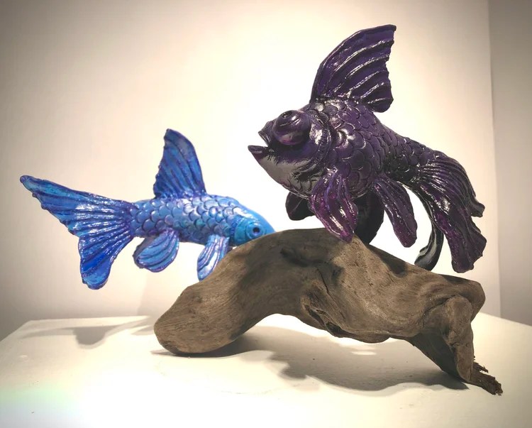 Blue and purple fish sculptures by Lauren Noorlag
